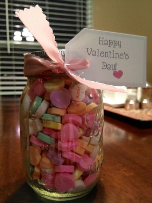 Colorful candy hearts in a mason jar with a Happy Valentine's Day tag