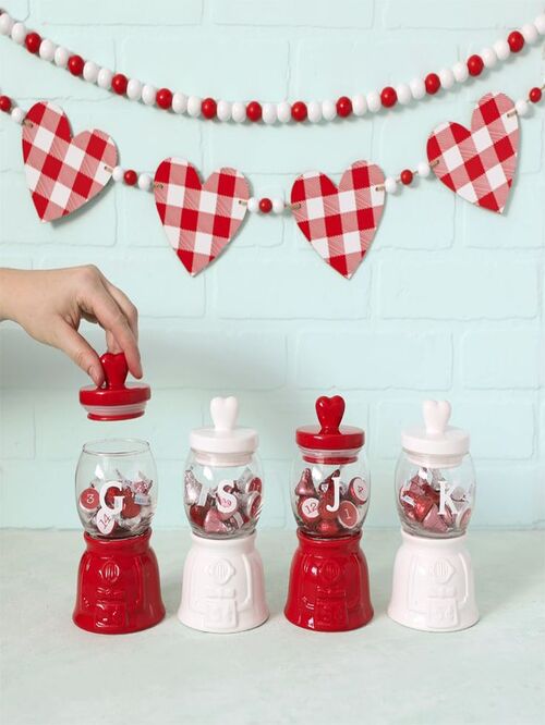 white and pink jars filled with 14 candies for Valentine's day