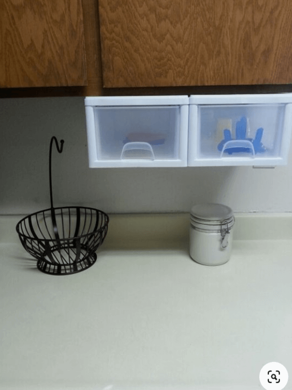 baby stuff in baskets under the cabinets