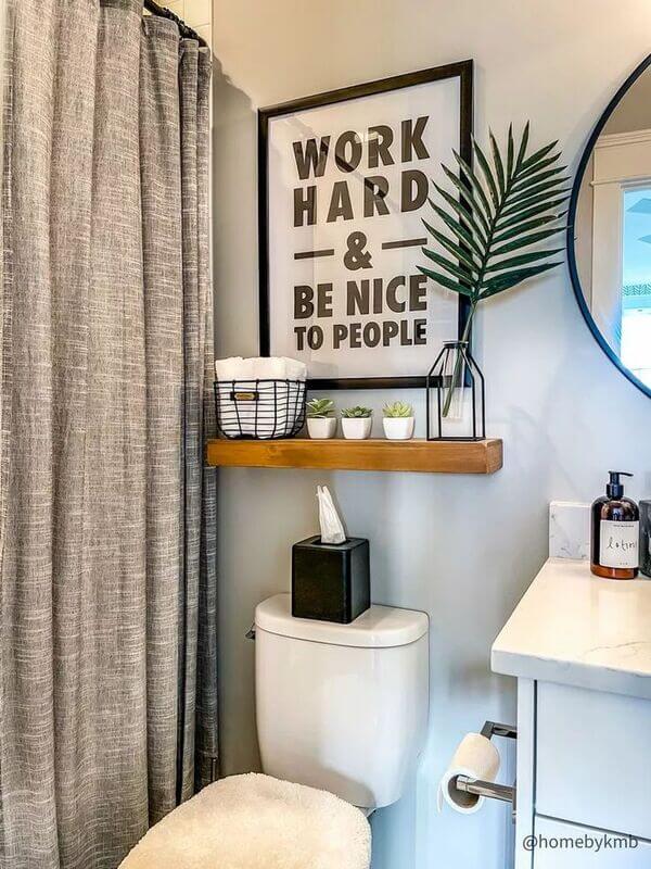 over the toilet decorative floating shelves with art and plants and wire basket
