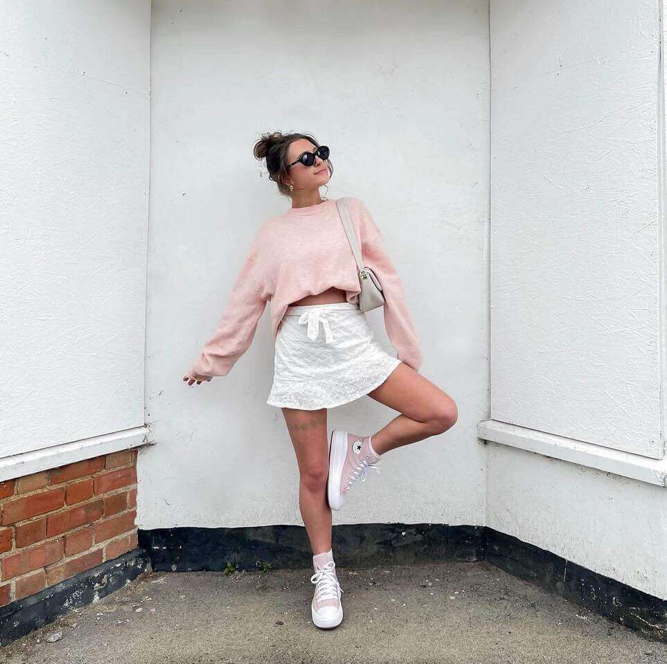 light pink sweater and mini skirt outfit