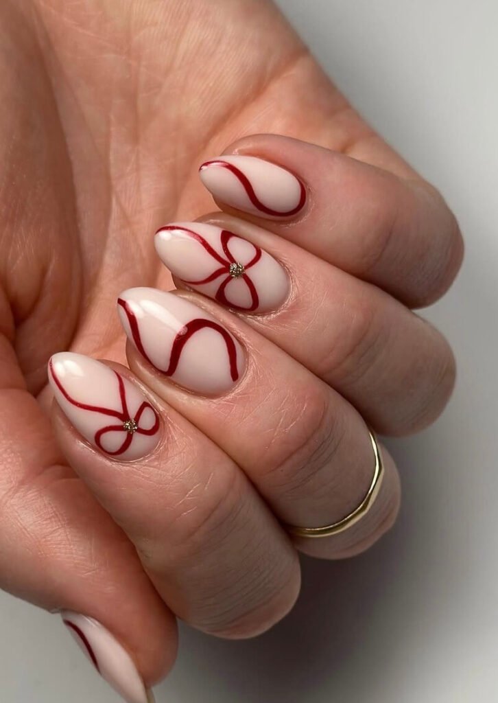 almond red bow nails 